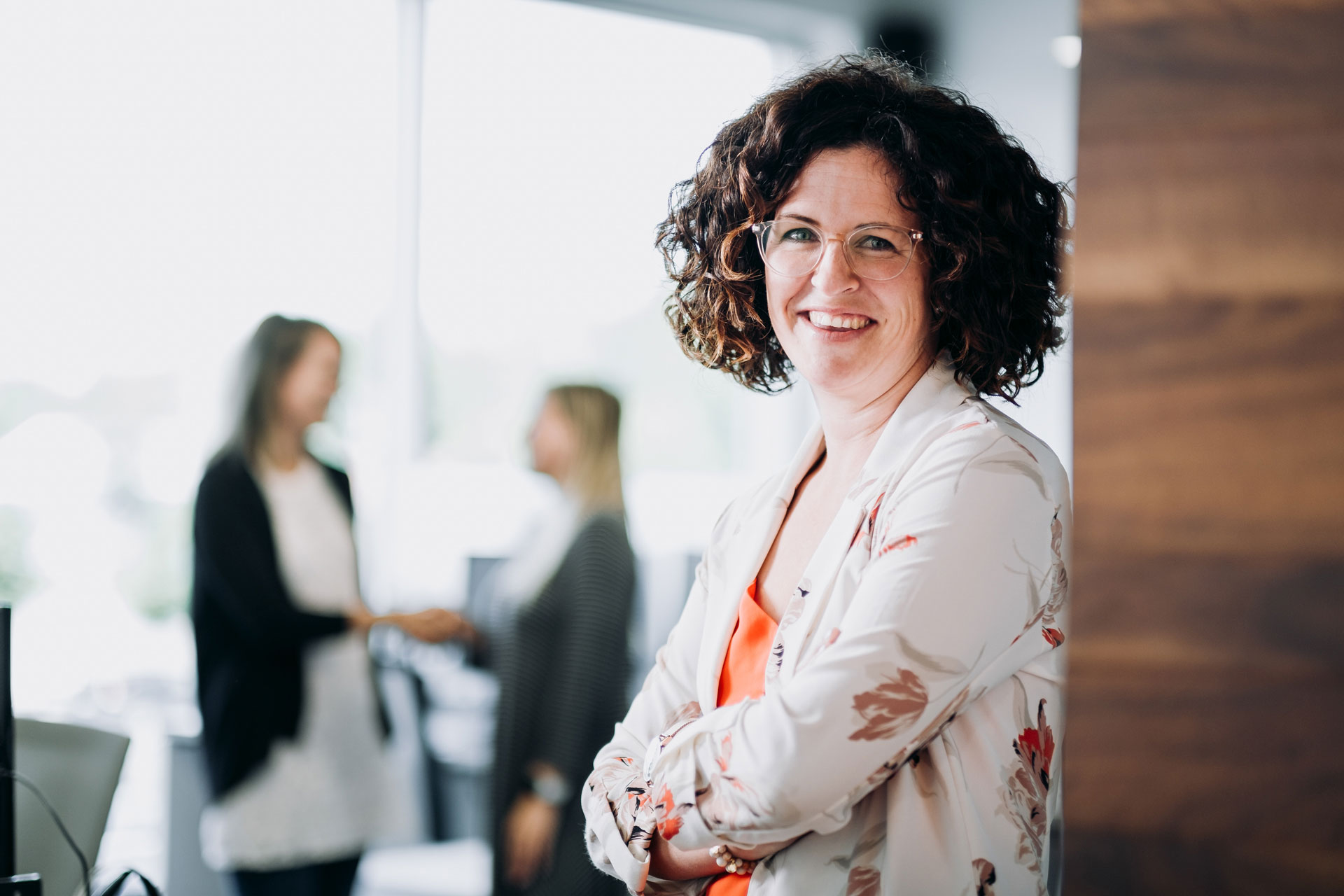 Smiling employee with crossed arms
