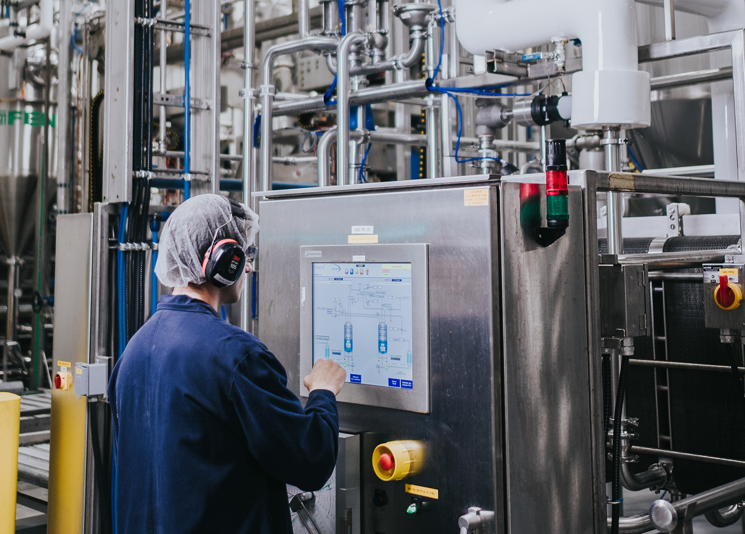 technician using Fruit d'Or's equipment for cranberry puree in one of Fruit d'Or's facility