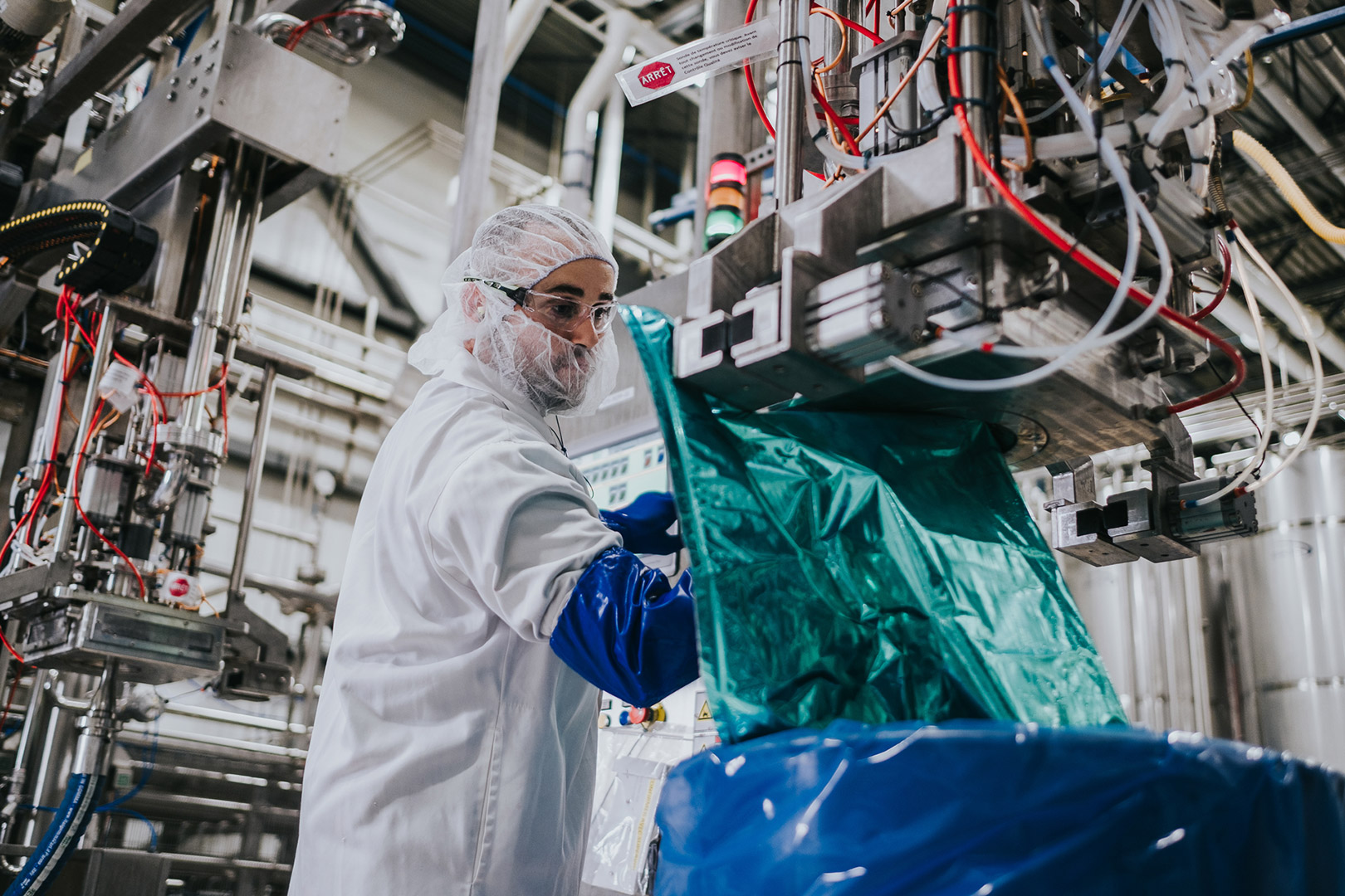 Fruit d'Or technician adjusting the settings on a machine used in the fabrication of blueberry puree